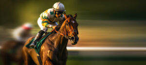 A jockey on a horse in motion. A background with motion blur as negative space.